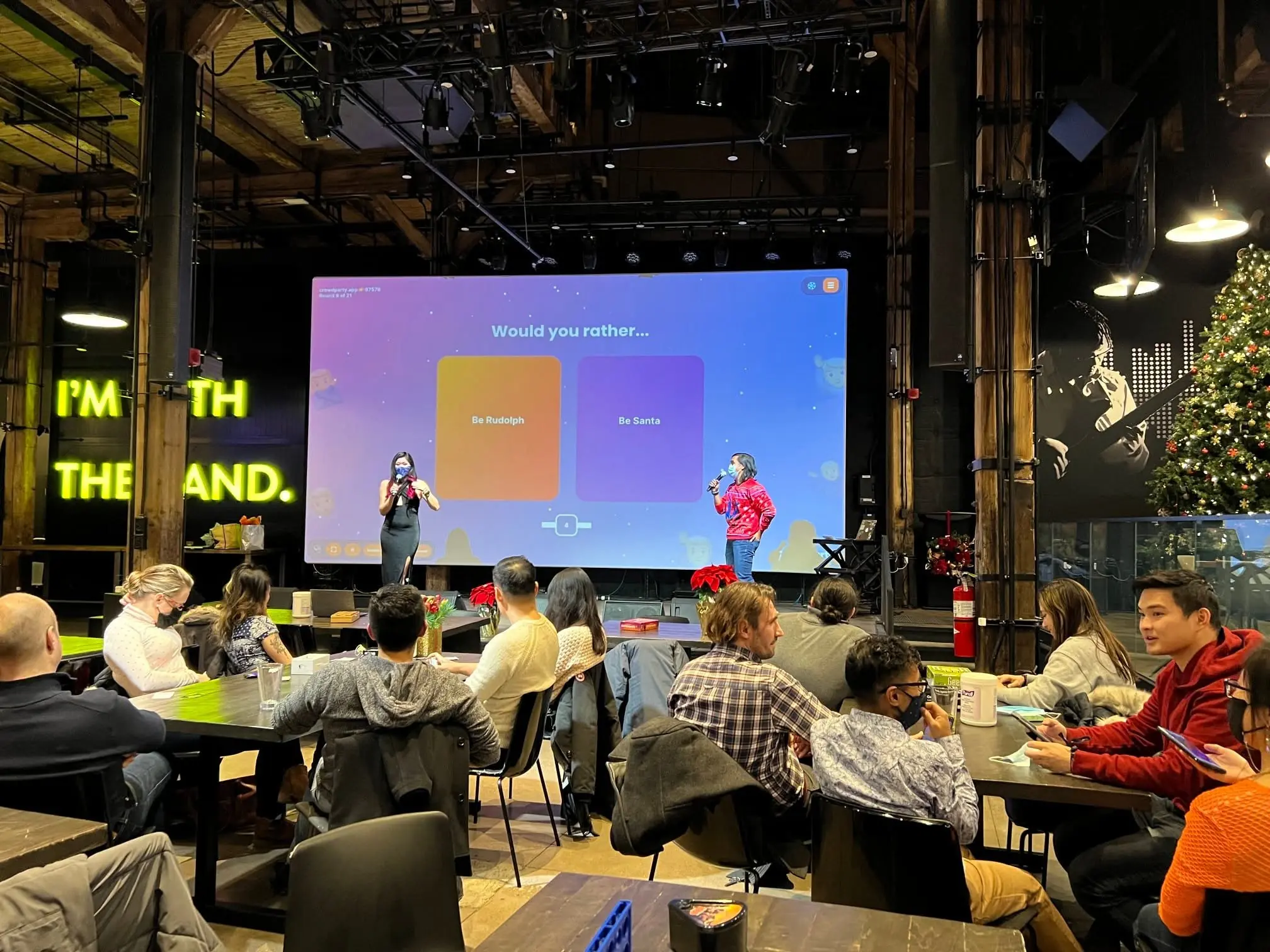 People playing CrowdParty together with a shared screen at an in-person event
