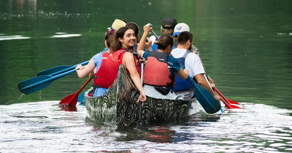 Participants paddling a Toronto Adventures Voyageur canoe